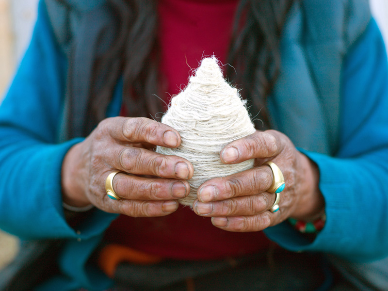 Bhutan - Rural life - A Layap woman from Laya holding a ball of sheep wool which was spun using a drop spindle called a Yoekpa