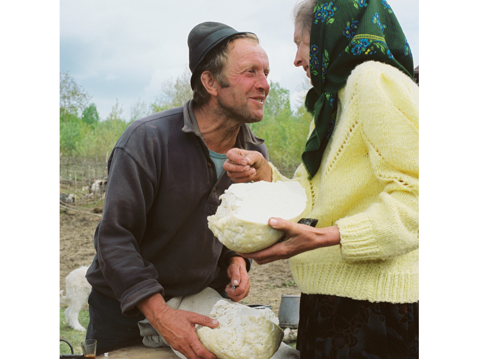 Romania - Carpathian mountains - Shepherd gives a villager her share of the cheese at a Measurement of the Milk festival in Maramures